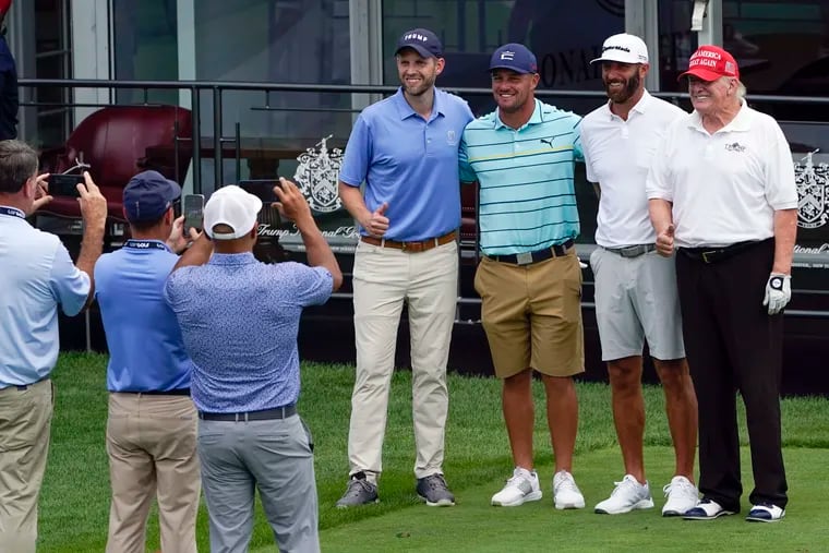 Former President Donald Trump (right), golfer Dustin Johnson (second from right), golfer Bryson DeChambeau (third from right), and Eric Trump posing for a picture as they played together during the pro-am round of the Bedminster Invitational LIV Golf tournament in Bedminster, N.J., on Thursday.