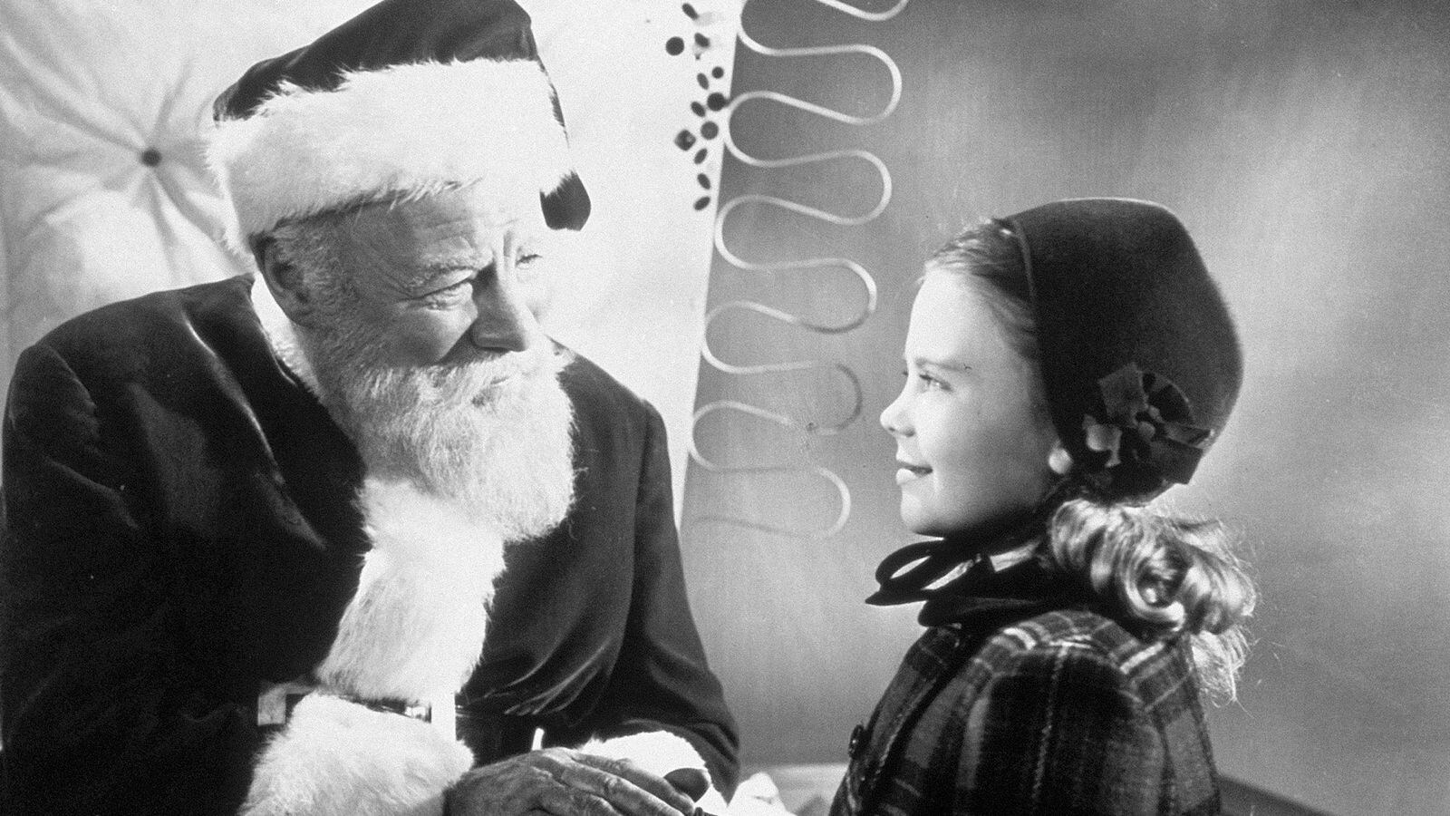 Actor Edmund Gwenn as Kris Kringle greets actress Natalie Wood in a scene from the 1947 film, Miracle on 34th Street.