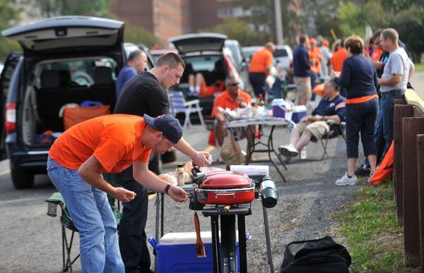 Fans fill the parking lots while tailgating before a Syracuse football game in 2014. Scott Schild | sschild@syracuse.com