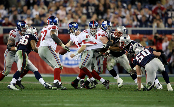 eli-manning-of-the-new-york-giants-breaks-free-from-the-grasp-of-of-picture-id79498566