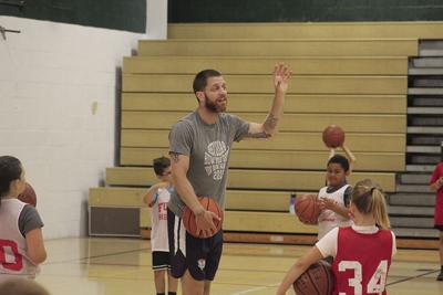 Former Syracuse basketball player Eric Devendorf helps with Fulton Youth Basketball Camp