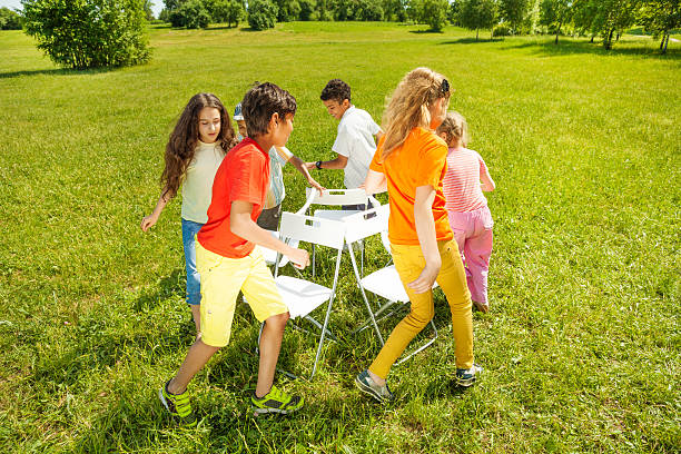 kids-run-around-playing-musical-chairs-game-picture-id506429829