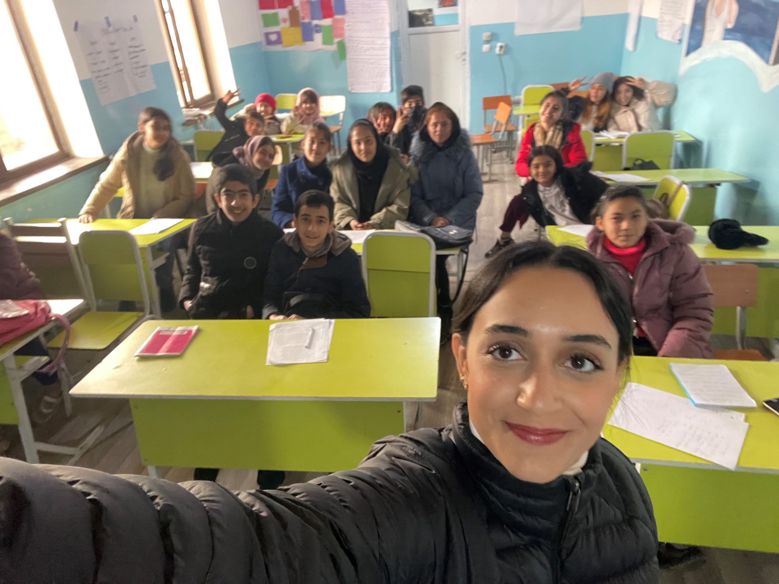 Kiana Khoshnoud '23 with some of her students in a classroom in Tajikistan.