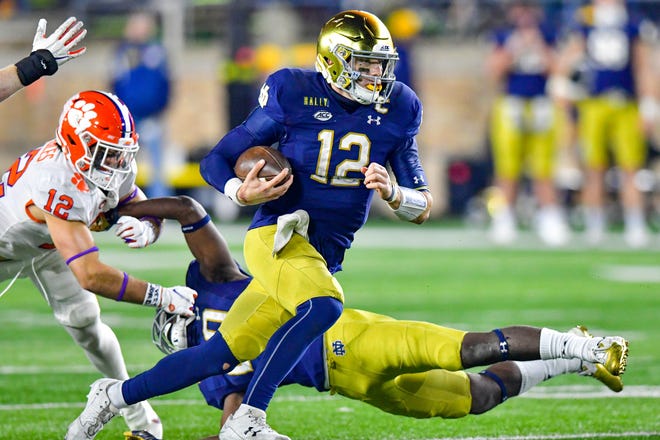 Notre Dame quarterback Ian Book finds running room as Clemson safety Tyler Venables pursues during the second overtime at Notre Dame Stadium.