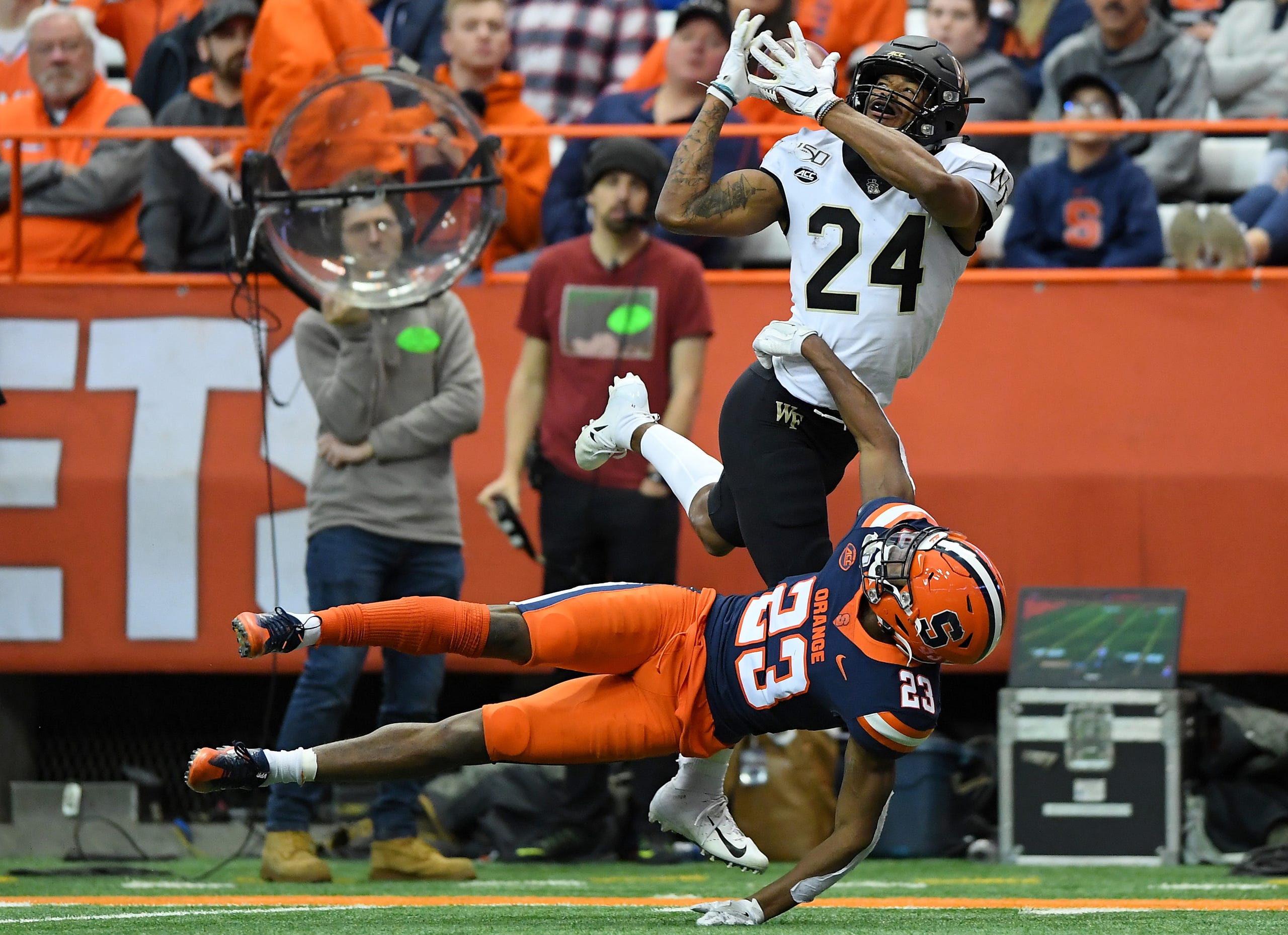 Wake Forest wide receiver Donavon Greene (24) catches a pass as Syracuse Orange defensive back Ifeatu Melifonwu (23) defends at the Carrier Dome on Nov. 30, 2019.