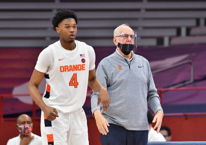 Syracuse Orange head coach Jim Boeheim and forward Woody Newton (4) watch the play on the court against the Rider Broncs.