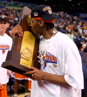 Syracuse's Carmelo Anthony kisses the NCAA men's basketball championship trophy after beating Kansas 81-78 on April 7, 2003, in New Orleans.