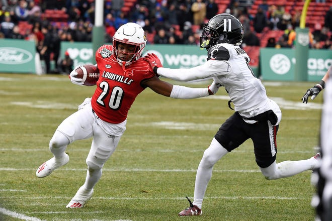 Louisville Cardinals running back Maurice Turner is forced out of bounds by Cincinnati Bearcats cornerback Sammy Anderson.